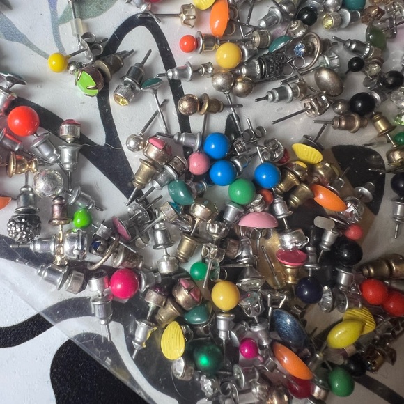 Bag full of different colored stud earrings. - Picture 8 of 13